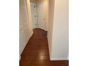 Hallway featuring hardwood floors, access to multiple rooms, and neutral paint at 11774 Via Lucerna Cir, Windermere, FL 34786