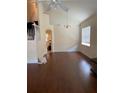 Open living room with soaring ceilings, hardwood floors, and a chandelier at 11774 Via Lucerna Cir, Windermere, FL 34786