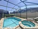 Enjoy this beautiful screened-in pool and hot tub with plenty of space for entertaining and relaxing on sunny days at 1612 Herrons Green Path, Kissimmee, FL 34747