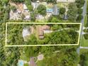 Expansive property with mature trees, as seen from an aerial view with property lines at 1775 Sundance Dr, St Cloud, FL 34771