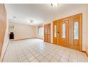 Bright entryway with tile flooring, decorative front door, and ample natural light at 1775 Sundance Dr, St Cloud, FL 34771