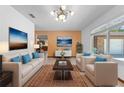 Bright living room featuring neutral furniture, complementary colored pillows, and large windows at 1775 Sundance Dr, St Cloud, FL 34771