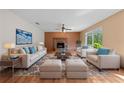 Cozy living room featuring a brick fireplace, neutral furniture, and natural light at 1775 Sundance Dr, St Cloud, FL 34771