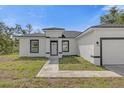 Charming single-story home featuring a black and white color scheme and well-manicured lawn at 2396 Sw 147Th Lane Rd, Ocala, FL 34473