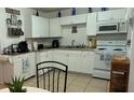 Cozy kitchen with white cabinets and modern appliances at 83 Douglas Way, Frostproof, FL 33843