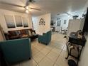 Bright living room with leather couches and tile floors at 83 Douglas Way, Frostproof, FL 33843