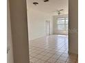 Bright living room with tile floors and access to other rooms at 13512 Turtle Marsh Loop # 736, Orlando, FL 32837