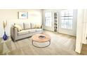 Comfortable living room featuring neutral colors, a sofa, and large windows at 1928 Drum Dr, Kissimmee, FL 34759