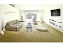 Spacious living room with modern furniture, plush carpeting, and ample natural light at 1928 Drum Dr, Kissimmee, FL 34759