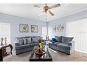 Inviting living room featuring two comfortable sofas, neutral carpet, and a stylish ceiling fan at 526 Maricopa Dr, Kissimmee, FL 34758