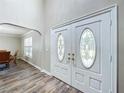 Double doors with glass inserts and wood-look flooring in the entryway at 32122 Hickory Ln, Sorrento, FL 32776
