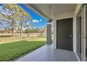 Outdoor patio area with a view of well-maintained green space, offering a serene and private outdoor experience at 13953 Fairway Island Dr # 616, Orlando, FL 32837