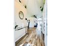 Inviting entryway with wood flooring, high ceilings, and modern decor at 144 Rose Hill Trl, Sanford, FL 32773