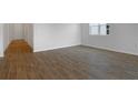Bright living room with sleek wood-look tile floors and neutral walls at 192 Flag Lilly Ln, Umatilla, FL 32784