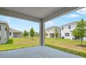 Covered back patio overlooking the sprawling backyard, great for outdoor relaxation and entertainment with neighborhood views at 196 Flag Lilly Ln, Umatilla, FL 32784
