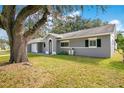 A lovely one story home featuring an attached garage, arched entryway, and mature tree in the front yard at 3000 Cashmere Dr, Orlando, FL 32827
