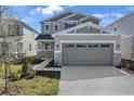 Charming home with a large two-car garage, stone accents, and a landscaped front yard at 195 Bull Frog Ln, Umatilla, FL 32784
