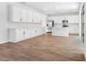 Spacious kitchen with white cabinetry, stainless steel appliances, and a large center island at 1496 August Gray Dr, Kissimmee, FL 34744