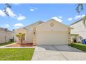 Lovely one-story home featuring a two-car garage, landscaped yard, and neutral color palette at 1548 Tiverton Blvd, Winter Garden, FL 34787