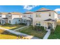 Street view of three modern two-story homes with well-manicured lawns and sidewalks at 1853 Summer Serenity Dr, Kissimmee, FL 34744