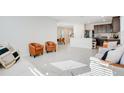 Open-concept living room featuring tile floors and an open view to dining and kitchen at 1853 Summer Serenity Dr, Kissimmee, FL 34744