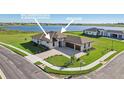 Beautiful new construction home with paver driveway, lush lawn, and incredible lake views at 267 Spinnaker Ct, Auburndale, FL 33823