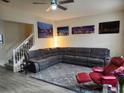 Comfortable living room showcasing a sectional couch, a grey area rug, and Venice-themed wall art at 319 Celebration Blvd, Celebration, FL 34747