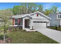 Charming single-Gathering home featuring a two-car garage and appealing curb appeal with a landscaped front yard at 4235 Sawtooth Ct, Tavares, FL 32778