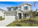 Charming two-story home featuring a two-car garage, stone accents, blue shutters and landscaped front yard at 535 Summit River Dr, Apopka, FL 32712