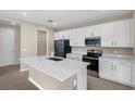 Modern kitchen with stainless steel appliances, white cabinetry, island and a pantry at 535 Summit River Dr, Apopka, FL 32712