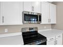 The kitchen features stainless steel appliances, white cabinets, and quartz countertops at 535 Summit River Dr, Apopka, FL 32712