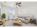 Cozy living area features a ceiling fan, window with natural light, and a comfortable sectional sofa at 1746 Pompano Dr, Poinciana, FL 34759