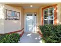 Inviting entryway features a white door and decorative metal art at 3445 Village Green Ct, Saint Cloud, FL 34772