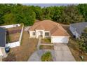 Aerial view of a single-Gathering home with a two-car garage, fenced yard, and mature landscaping at 2507 Monaco Cove Cir, Orlando, FL 32825