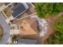 Drone shot of home's layout within the neighborhood showing roof, landscaping, and neighboring properties at 2507 Monaco Cove Cir, Orlando, FL 32825