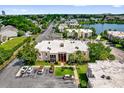 Aerial shot showcases building's setting by a serene lake in a neighborhood with mature trees at 544 Orange Dr # 10, Altamonte Springs, FL 32701