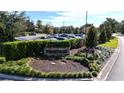 Bay Hill Club & Lodge entrance featuring manicured landscaping, stone signage, and ample parking at 6258 Masters Blvd # C204, Orlando, FL 32819