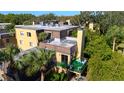 Aerial view of the condo exterior showcasing a rooftop patio and proximity to lush greenery at 6258 Masters Blvd # C204, Orlando, FL 32819