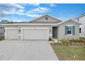 Charming single-story home with a two-car garage and a meticulously maintained front yard at 2107 Riley Ave, Eagle Lake, FL 33839