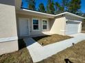 Front entrance with white door and walkway leading to the house at 6809 149Th Lane Rd, Ocala, FL 34473