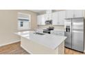Modern kitchen features stainless steel appliances and an island with a sink at 814 Ballantyne Dr, Lake Wales, FL 33898