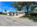 Attractive single story home with an attached garage shaded by a mature tree and a well manicured lawn at 1493 Magellan Cir # 504, Orlando, FL 32818
