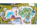 Aerial view of community amenities, including pools, a lazy river, and miniature golf at 2769 Bookmark Dr, Kissimmee, FL 34746
