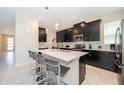 Modern kitchen with stainless steel appliances, white countertops, and a breakfast bar at 2769 Bookmark Dr, Kissimmee, FL 34746