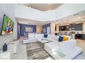 Bright living room featuring a high ceiling, modern decor, and sleek furniture at 2769 Bookmark Dr, Kissimmee, FL 34746