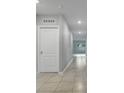 Hallway showcasing ceramic tile flooring, neutral walls, and ample lighting fixtures at 3617 Scarlet Oak Dr, St Cloud, FL 34772