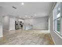 Open kitchen featuring stainless steel appliances, a breakfast bar, and ceramic tile flooring at 3617 Scarlet Oak Dr, St Cloud, FL 34772