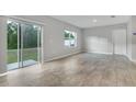Bright living room featuring ceramic tile flooring, sliding glass doors and backyard view at 3617 Scarlet Oak Dr, St Cloud, FL 34772
