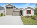 Beautiful single-Gathering home featuring a two-car garage, manicured lawn, and neutral stucco at 2007 Stetson Ave, Eagle Lake, FL 33839