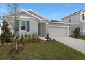 Beautiful single-Gathering home with a two-car garage, complemented by landscaping at 1651 Sugarbelle Cir, Mascotte, FL 34753